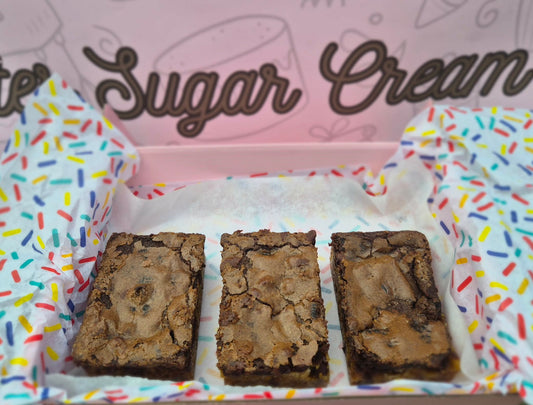 Three brownies in a box with colorful sprinkles and 'Butter Sugar Cream' branding.
